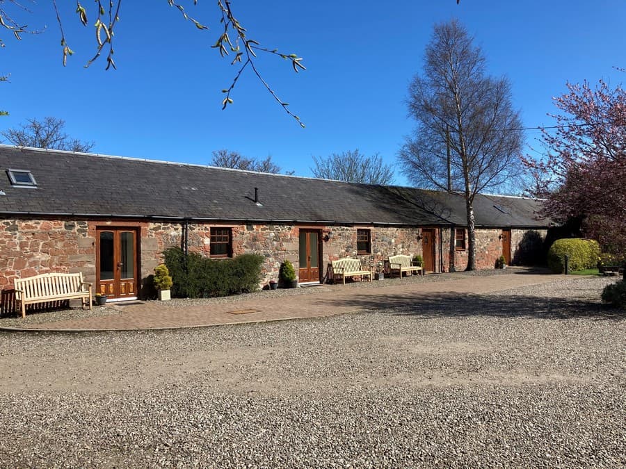 Exterior of the converted red sandstone stable apartments at Perthshire Courtyard