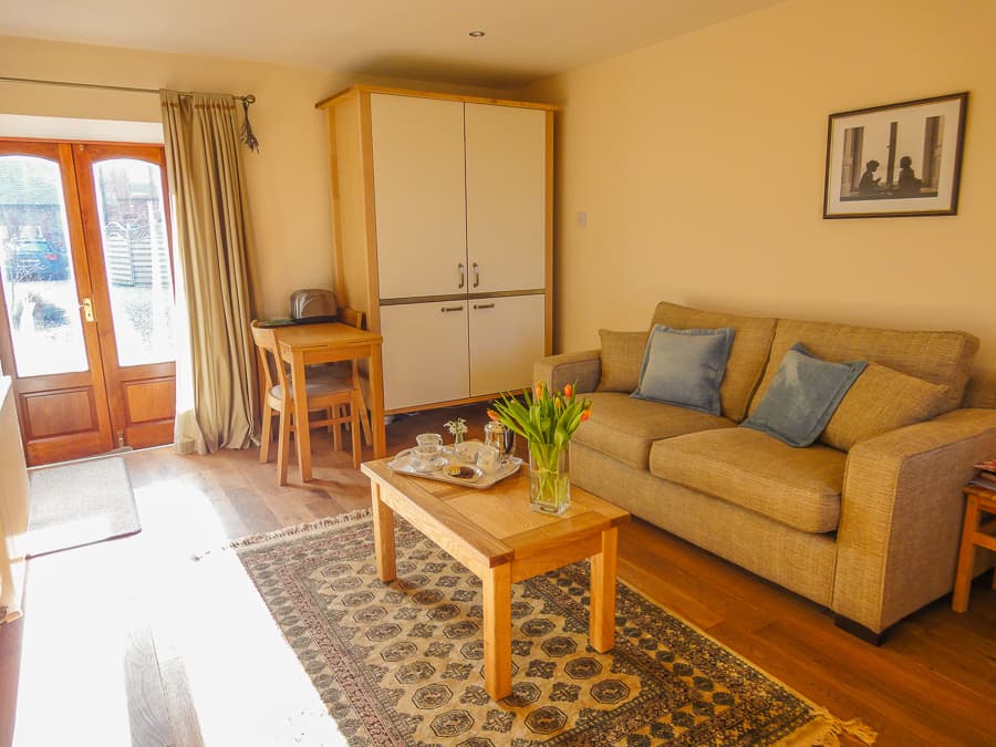 Open-plan sitting room and kitchenette in a Perthshire Courtyard apartment
